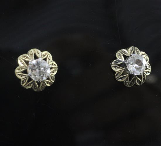 A pair of gold and solitaire diamond ear studs,